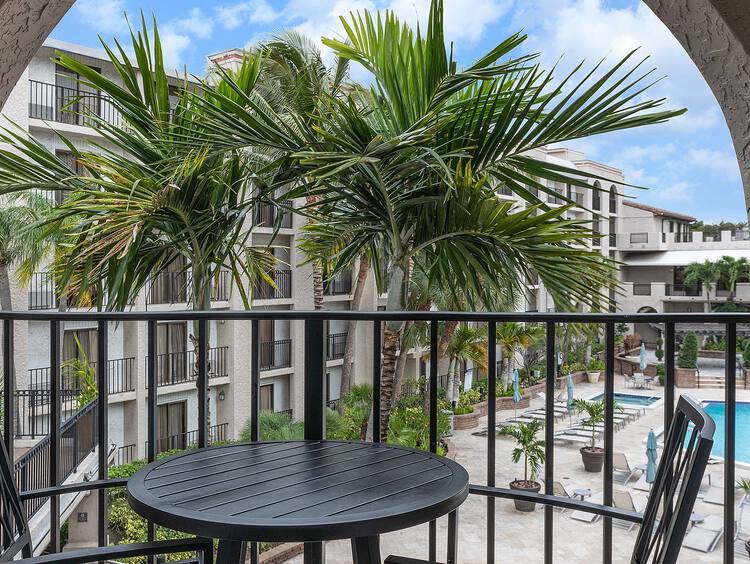 Private balcony with a table and chairs